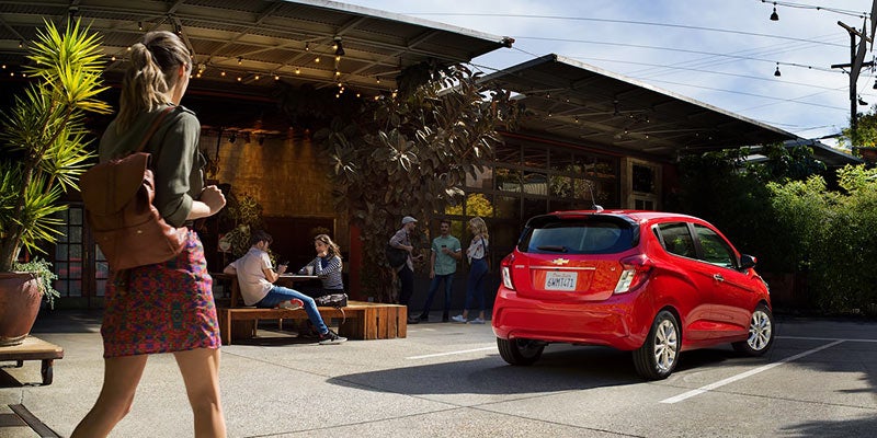 Girl walking towards 2022 Chevrolet Spark