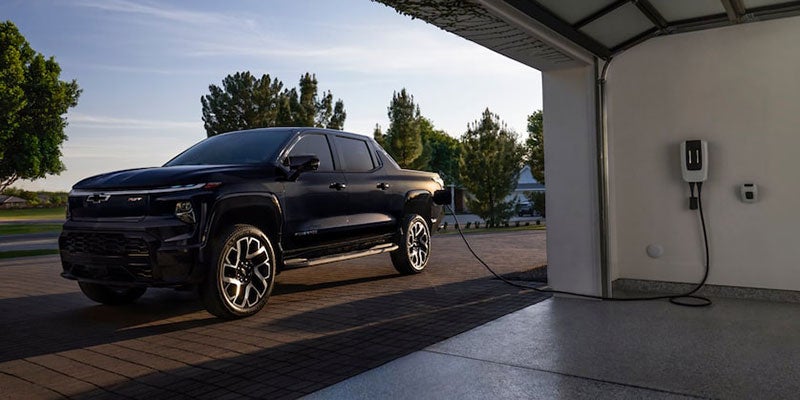 A black 2024 Chevrolet Silverado Ev being charged