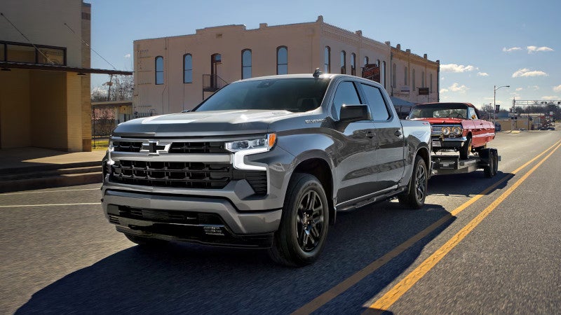 2026 Chevrolet Silverado 1500 Towing a red vehicle