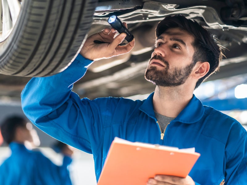 Ray Chevrolet Technician working under a vehicle
